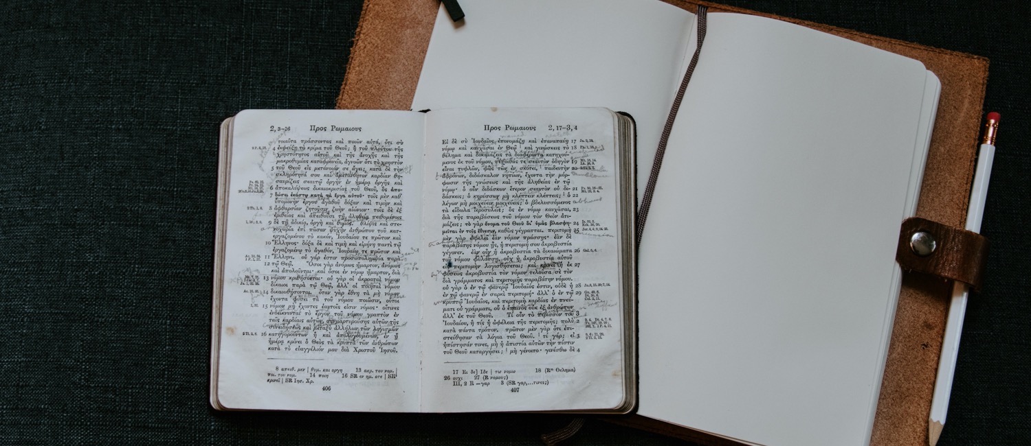 Greek book sitting on top of empty notebook